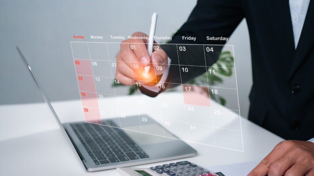 Businessman marking dates on virtual calendar, managing his busi - Bidaya Global